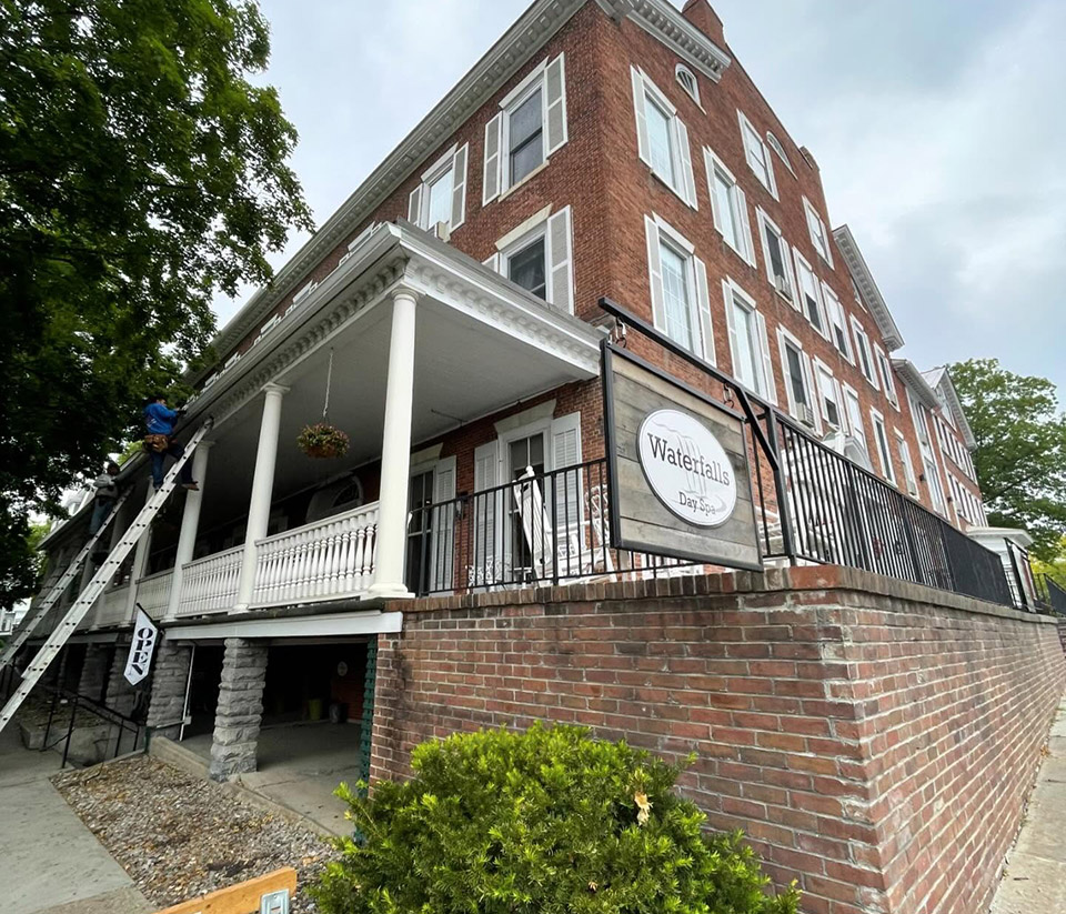 vermont-gutter-company-burlington-vt-7 Brick commercial building in Burlington, VT, with white-trimmed windows and white gutters.